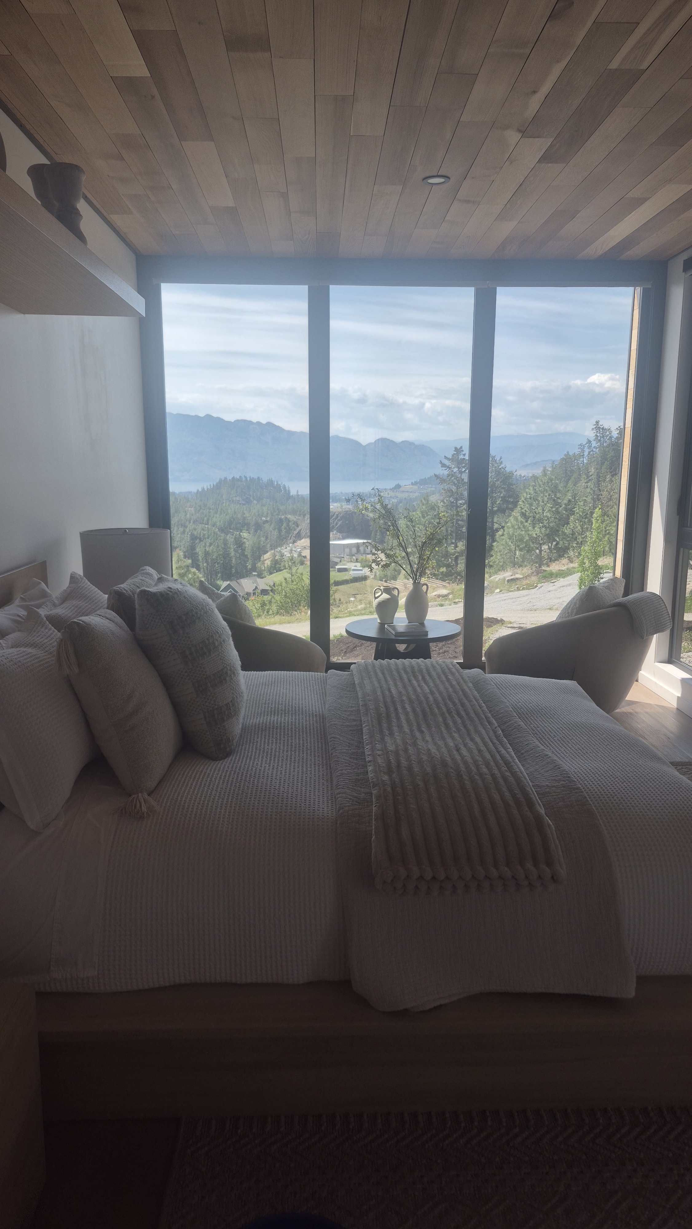 Freshly prepared bedroom overlooking a natural landscape