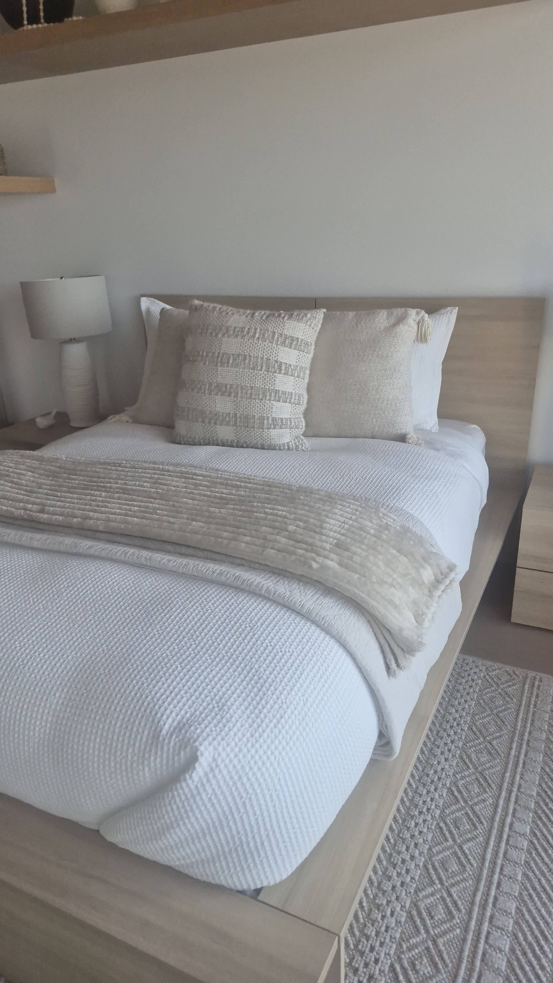Bright, freshly prepared bedroom with crisp neutral bedding